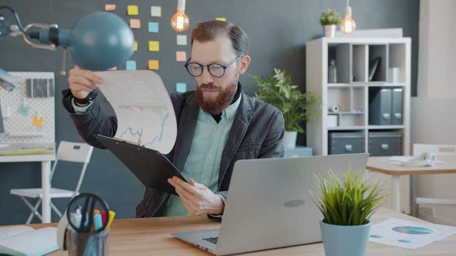 Analyst reviewing documents at a desk